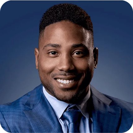 A professional headshot of Karlton Dennis in a suit.