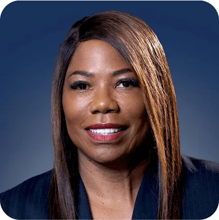 A professional headshot of Karla Dennis in a business jacket.