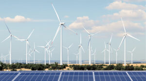 A field of wind turbines and solar panels representing clean energy eligible for the 2025 production tax credit.