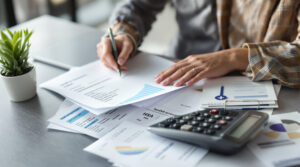 A self-employed person at a desk reviewing documents to understand their health savings account.